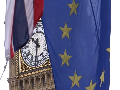 EU and UK flags are waving in front of Big-Ben, London, UK Stock Footage 75642846