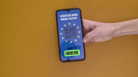 EU digital covid immunity passport on smartphone screen. Hands gloves check in Stock Footage 148341007