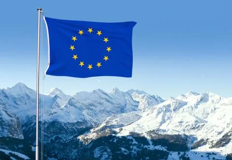 EU Flag Flying Over Alpine Scenery Stock Photos