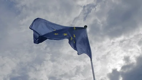 EU flag waving in the wind against a blue sky. The concept of patriotism. Slow Stock Footage 108616464
