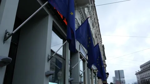 EU flags in front of builing with ticker Stockbeeldmateriaal 60701693