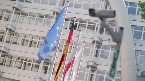 EU flags wave behind a cctv security camera on a pole in Berlin Video stock 102845028