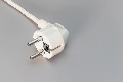 EU plug on a gray background. Home electrician. Close-up. Full focus. Photos