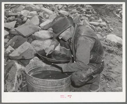Eugene Davis panning gold. Pinos Altos, New Mexico 1940. still image. Phot... Stock Photos