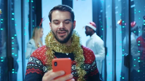Euphoric bearded man reading exciting news or Christmas wish on smartphone Stock Footage 121120593