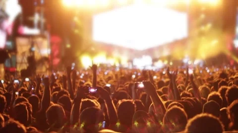 Euphoric crowd dancing and raised smartphone Stock Footage 63283210