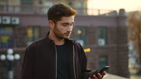 Euphoric guy receiving message phone outdoors. Excited man gesturing like winner Stock Footage 135473393