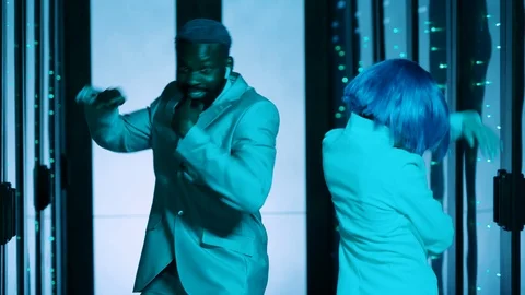 Euphoric multi-ethnic team of IT workers dancing together in dark database Stock Footage 121122782