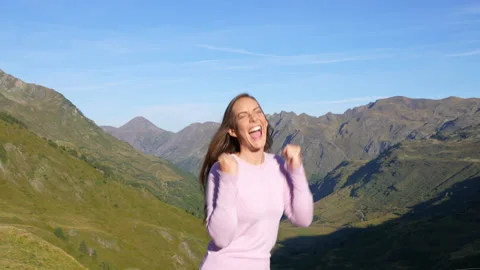 Euphoric woman celebrating laughing in the mountain Stock Footage