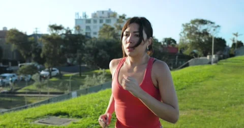 Eurasian female running through the park Stock Footage 138252753