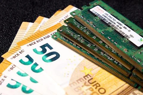 Euro banknotes and computer ram modules on black surface Stock Photos