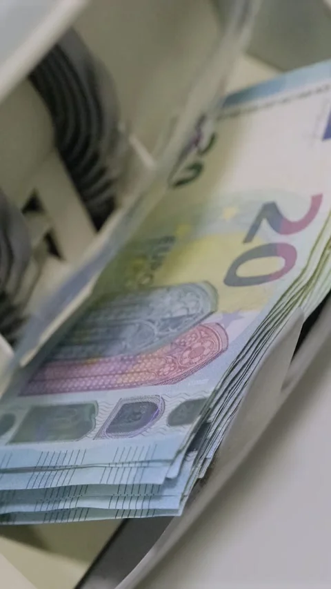 Euro banknotes are being processed quickly through an automatic money counting Stock Footage 317737208