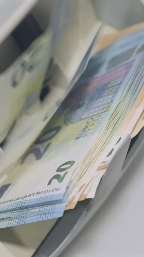 Euro banknotes are being processed quickly through an automatic money counting Stock Footage 317737210