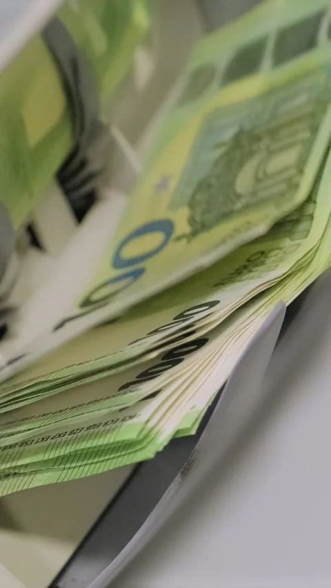 Euro banknotes are being processed quickly through an automatic money counting Stock Footage 317737212