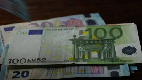 Euro banknotes of different denominations fall on table. Many euro currency Stock Footage 304349477