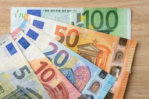 Euro banknotes of different face value fanned out on the table. Stock Photos