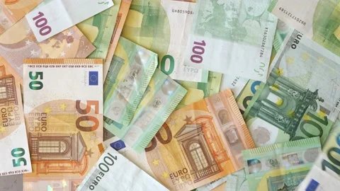 Euro banknotes falling on table. Cash 100 and 50 euro banknotes fall from above Stock Footage 219488420
