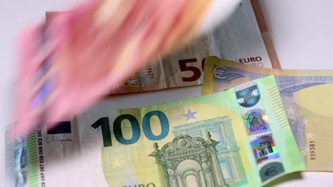 Euro banknotes falling onto a table. Close up of euro cash in motion. Stock Footage 324784705