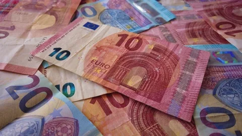 Euro banknotes falling on a table covered with banknotes. Close up Stock Footage 146282340