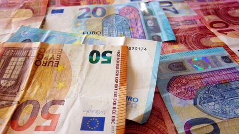 Euro banknotes falling on a table covered with banknotes. Close up Stock Footage 146282361