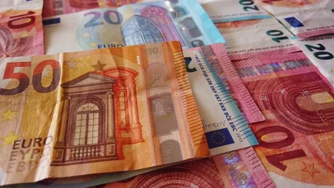 Euro banknotes falling on a table covered with banknotes. Close up Stock Footage 146282591