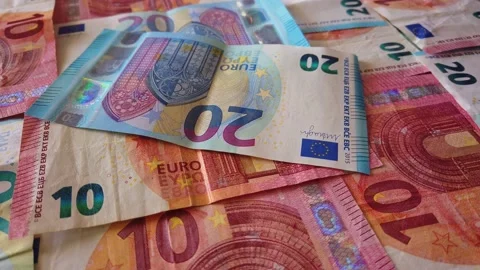 Euro banknotes falling on a table covered with banknotes. Close up Stock Footage 146282618