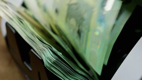 Euro banknotes passing through an automatic money counter before currency exchan Stock Footage 341701305