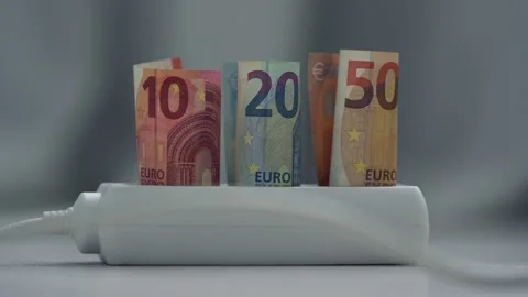 Euro banknotes plugged into plastic power strip over light background. Stock Footage 207458853