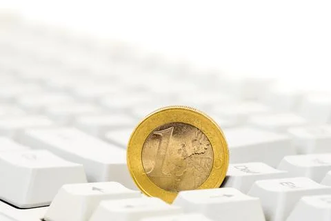Euro coin on computer keyboard background Stock Photos