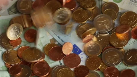 Euro coins falling to banknotes surface slow motion Stock Footage 45925387