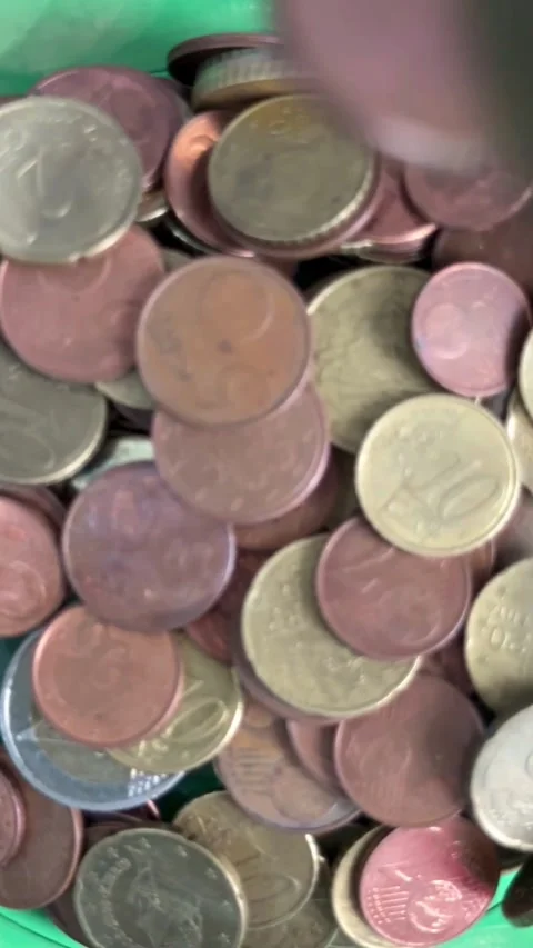 Euro coins falling into a container with other money Stock-Footage 331976641