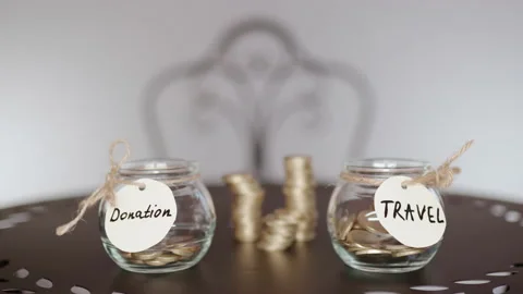 Euro coins falling down inside transparent jar with travel inscription Stock Footage 146660354