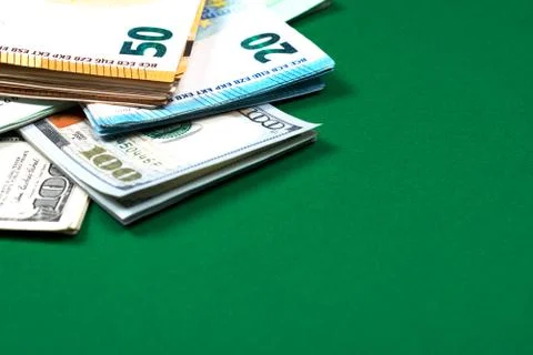 Euro notes and dollar bills on green background. Stock Photos