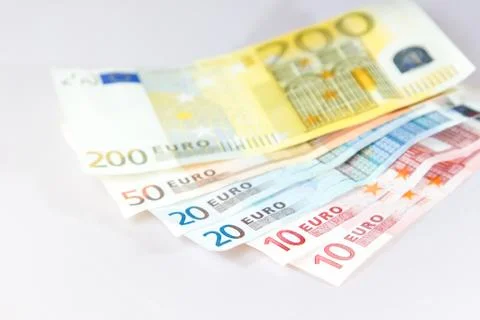 Euro notes lying on other notes with white background Stock Photos