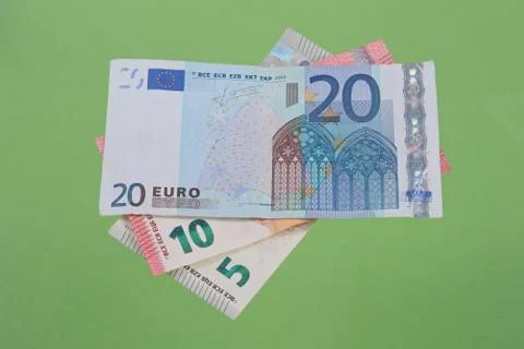 Euro notes on a plain green background. Stock Photos