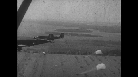 EUROPE, 1930s: View of back of plane as German paratroopers jump and open Stock Footage 75169077