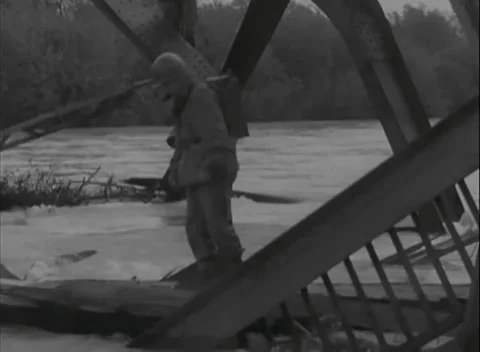 EUROPE - 1945: Collapsed bridge - Troops enter twisted bridge steelwork Stock Footage 344491551