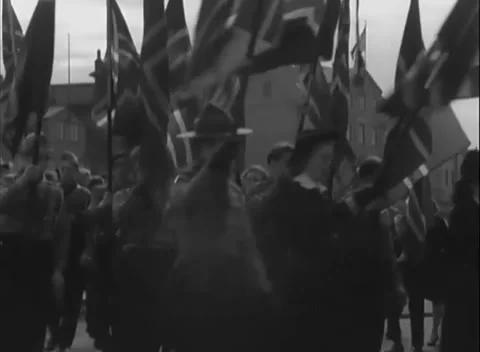 EUROPE - 1945: V-E Day parade - Flag bearers march beneath bright sky Видео 344491520