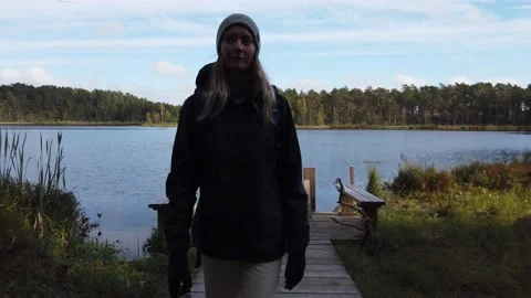 Europe Estonia: Woman by Lake and Forest in Nature Walking Stock Footage