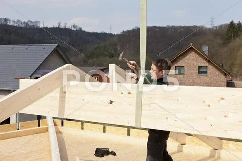 Europe, Germany, Rhineland Palantinate, Man assembling ridge purlin Stock Photos