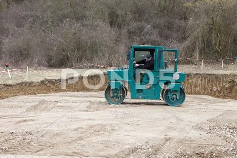 Europe, Germany, Rhineland Palatinate, Man rolling land with steamroller for Stock Photos
