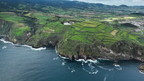 European agricultural patchwork fields bordering rocky Atlantic coastline Stock Footage 331261379