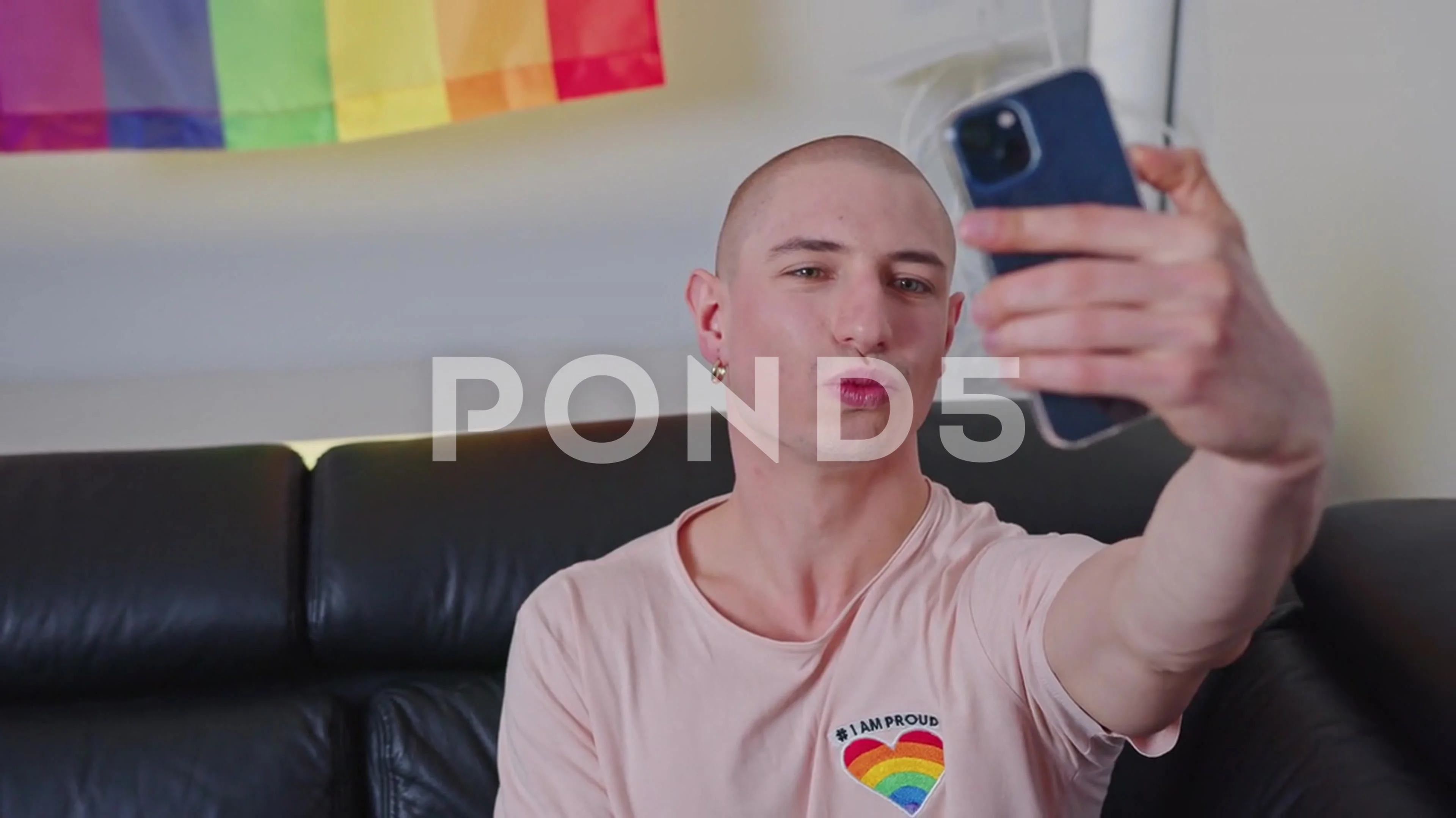 European caucasian bald gay influencer talking selfies with his smartphone  while