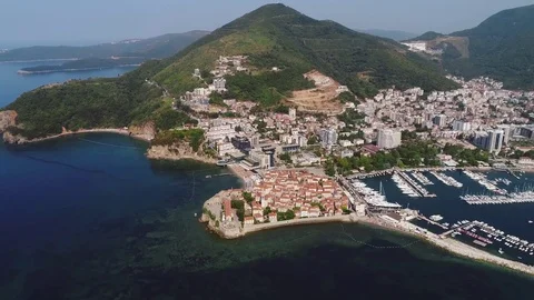 European city near the sea and mountains and a yacht berth. Aerial view. Stock Footage