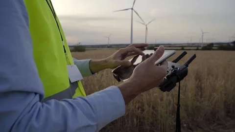 European engineer focused on using drone to inspect wind farm. People and Stock Footage 244597773