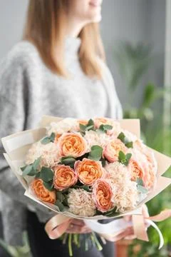 European floral shop. Beautiful bouquet of mixed flowers in womans hands. the Stock Photos