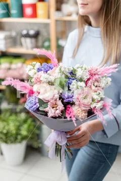 European floral shop. Bouquet of beautiful Mixed flowers in woman hand Stock Photos
