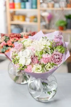 European floral shop. Two Bouquet Mixed beautiful flowers on wooden gray table Stock Photos