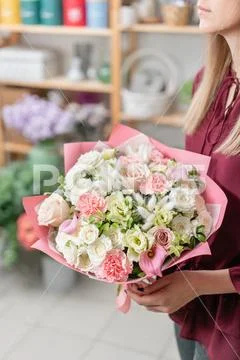 European floral shop. Two Bouquet of beautiful Mixed flowers in woman hand Stock Photos