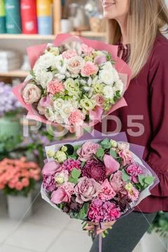 European floral shop. Two Bouquet of beautiful Mixed flowers in woman hand Stock Photos